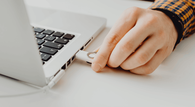 Person Plugging In a Thumb Drive